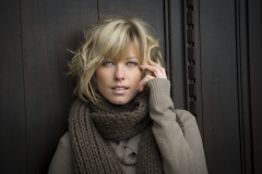 Attractive blonde young woman outdoors, looking at camera